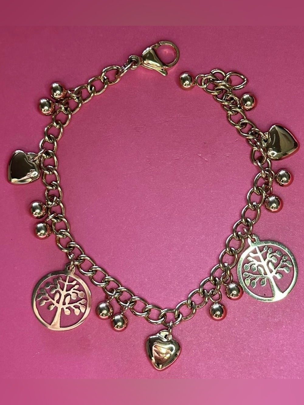 Tree of life golden tone chain charm bracelet.